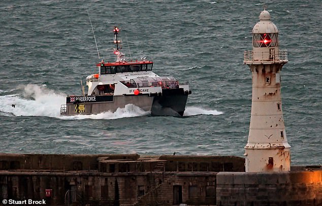 British Border Police officers escort migrants to the Dover Docks in Kent, United Kingdom