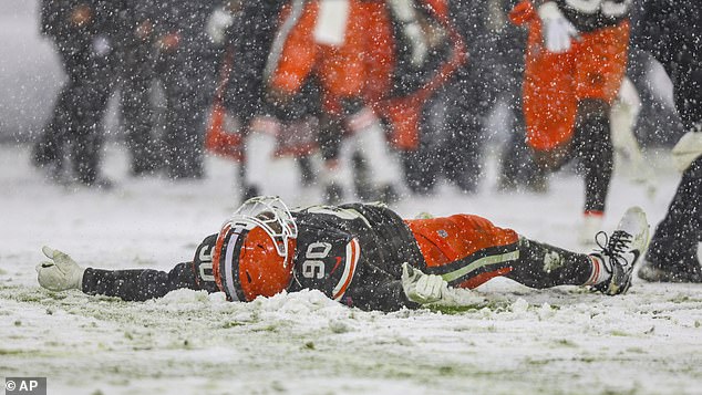 Cleveland Browns defensive tackle Maurice Hurst II (90) then makes a snow angel on the field