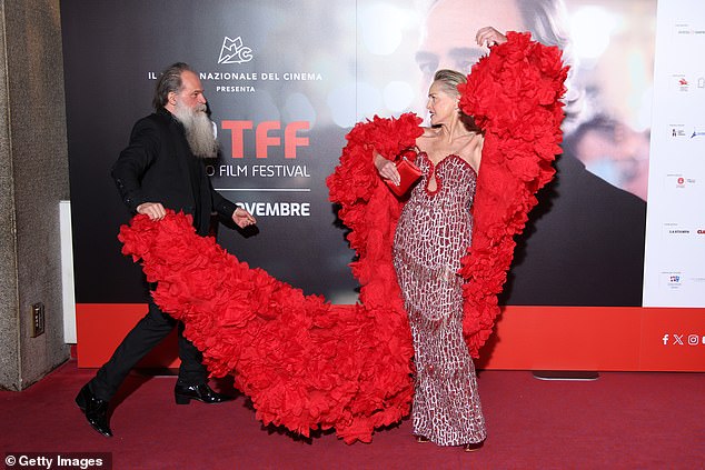 At one point, fashion designer Paris Libby was seen holding up the end of his long train as the glamorous star posed for photos