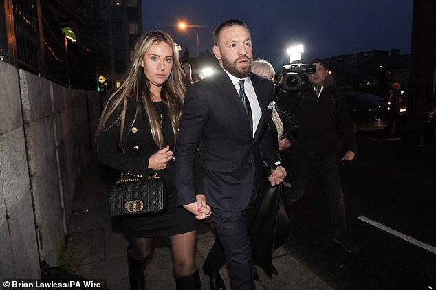 McGregor, pictured with his partner Dee Devlin at the High Court in Dublin this evening, was accused of 'brutally raping and assaulting' Nikita Hand.