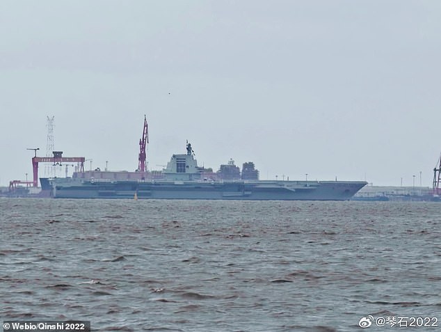 Images have emerged of China's Fujian ship (pictured), the largest in its naval arsenal, leaving its pier in the South China Sea on Monday