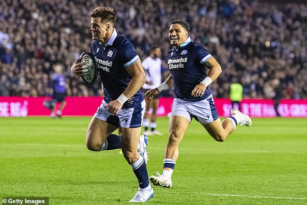 Huw Jones celebrates being on the scoresheet against Fiji together with Sione Tuipulotu