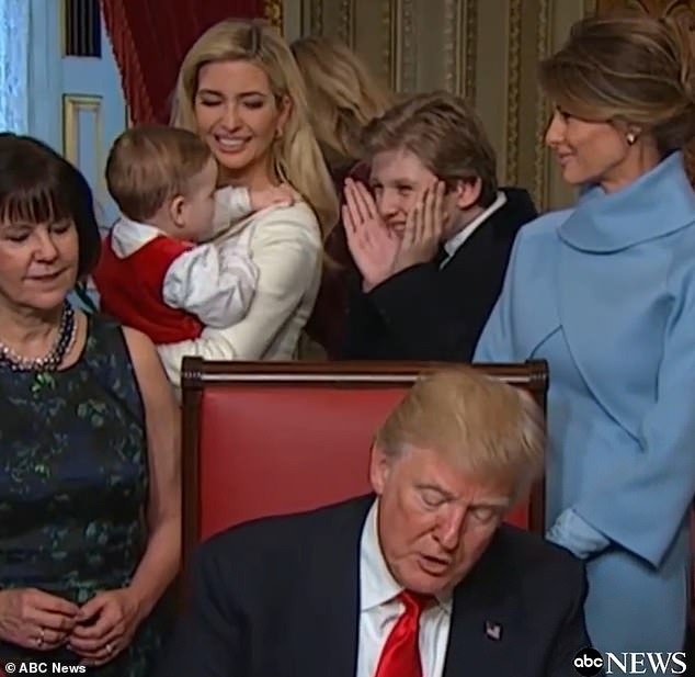 In the endearing clip, Barron starts playing peek-a-boo with Theo, who was dressed in a cute red onesie with a white shirt underneath