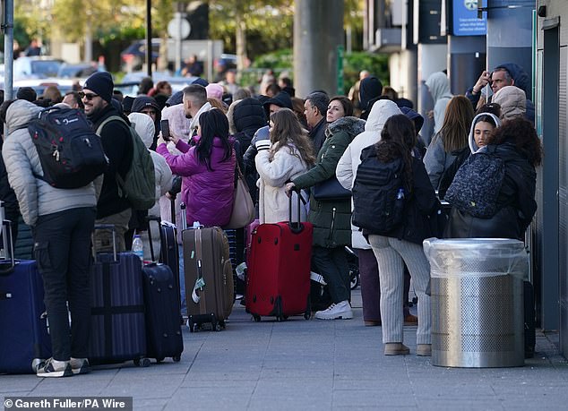 Crowds of passengers are waiting outside Gatwick Airport as numerous flights were delayed