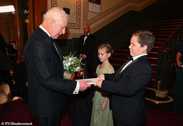 The monarch also accepted a posy meant for his wife from Louie Cooper, ten