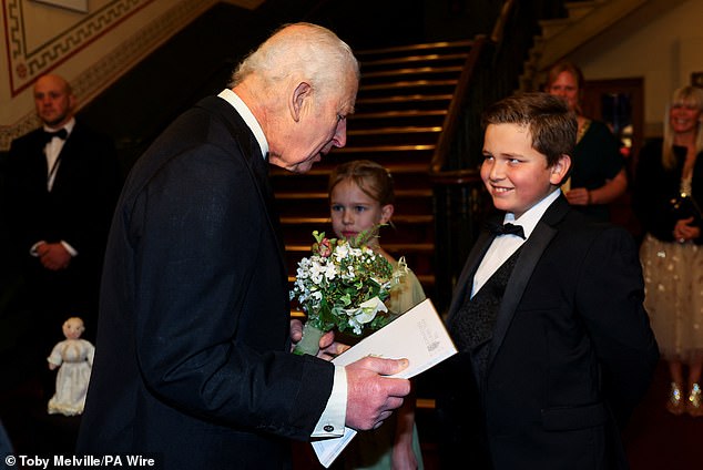 King Charles meets Iris King-Taylor and Louie Cooper, children of Royal Variety supporters