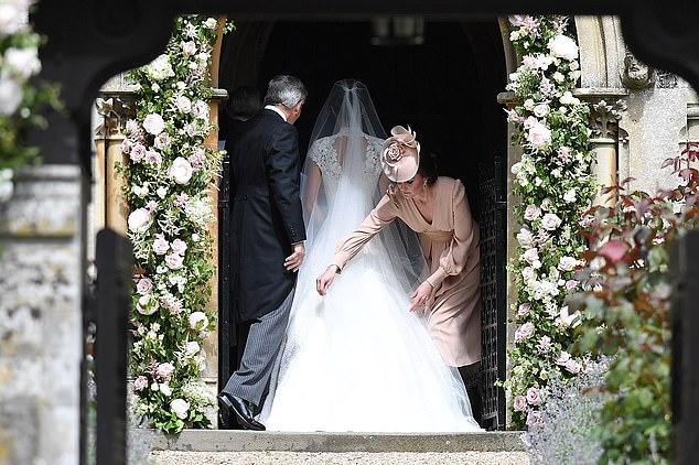 Kate tries on her sister's dress as she enters the church on her wedding day