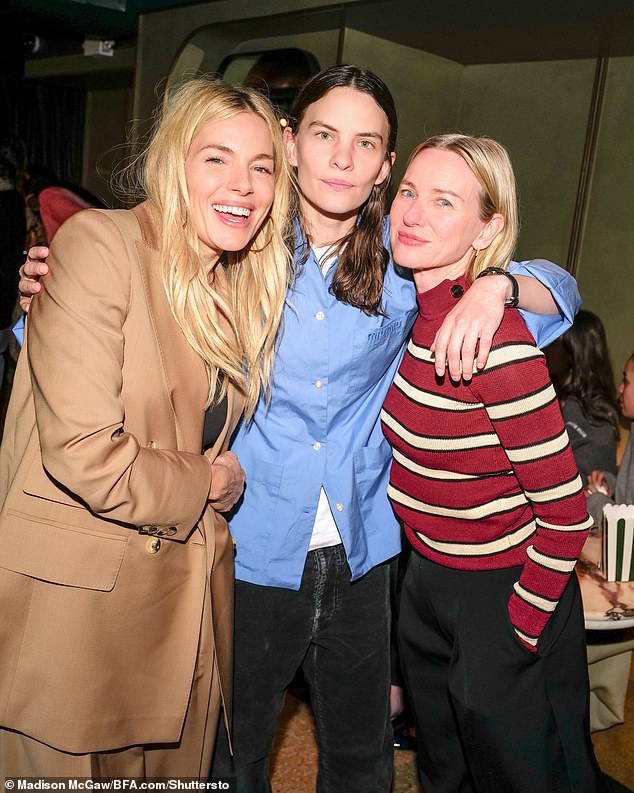 Meanwhile, Naomi Watts (right) cut a comfortable figure in a red and white striped jumper as she braved a storm alongside Sienna and Eliot Sumner (centre)