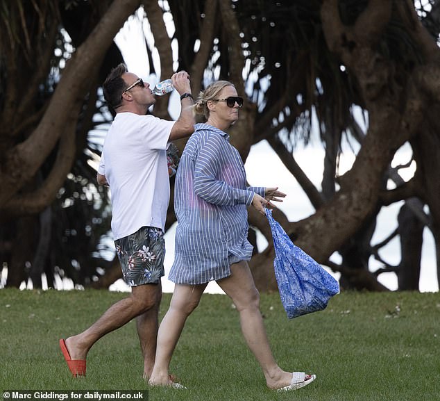 The new parents had the evening to themselves as they were pictured without their seven-month-old son, Wilder Patrick, returning from a walk at 6:30 pm with their beach towels.