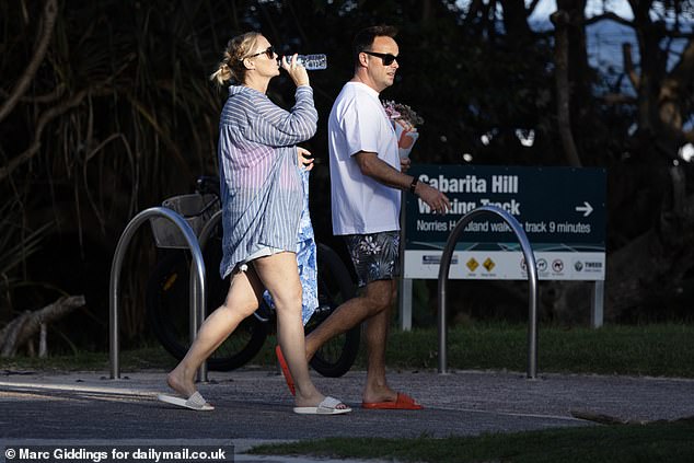 The couple wore flip-flops and sunshades as they enjoyed the casual stroll together