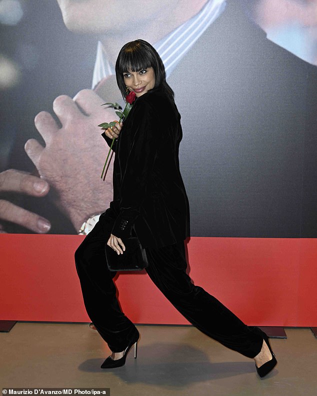 She paired the stylish blouse with a black velvet blazer and matching trousers as she posed up a storm at the event