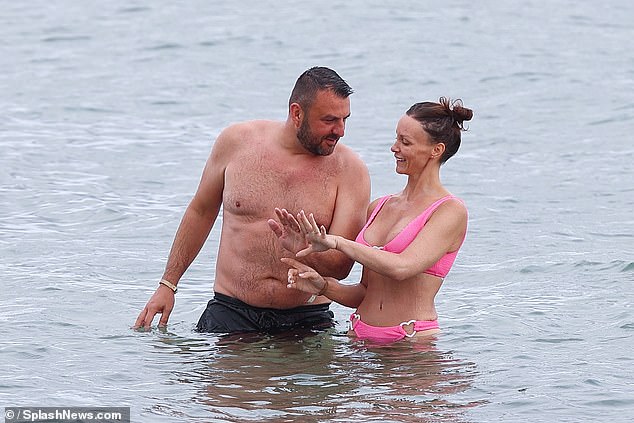 They admired their new wedding rings in the sea