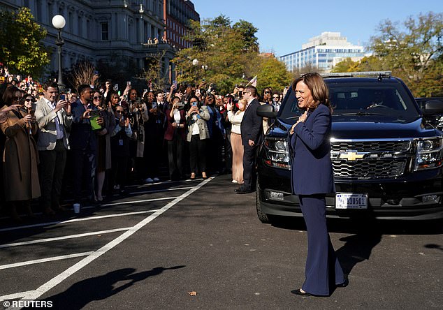 US Vice President Kamala Harris reacts as administration staff cheer her on outside the White House in Washington.