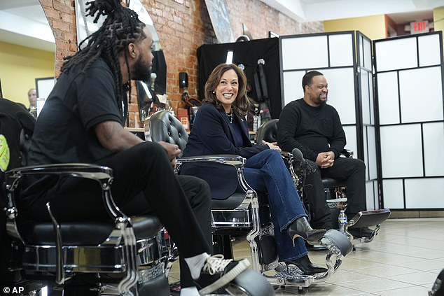 Democratic presidential candidate Vice President Kamala Harris, center, sits in conversation with black men at the Philly Cuts barbershop, Oct. 27, 2024, in Philadelphia