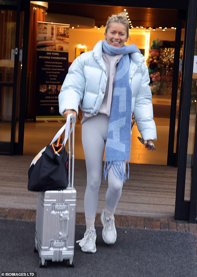 Tasha beamed for the cameras as she dressed warmly in a blue cropped puffer coat