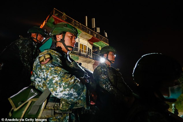 Taiwanese soldiers stand guard during the nighttime military exercises 'Chen-Chiang' in Penghu, Taiwan