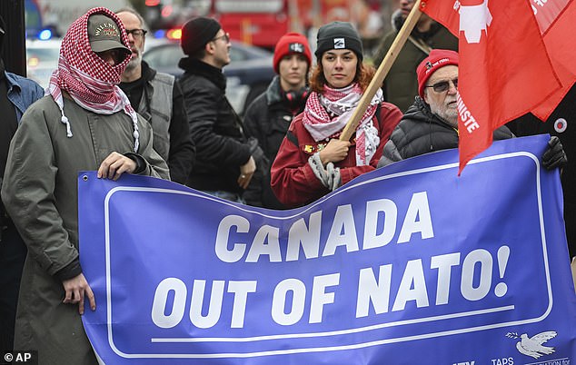 People wearing Palestinian-style keffiyehs take part in a protest against NATO in Montreal