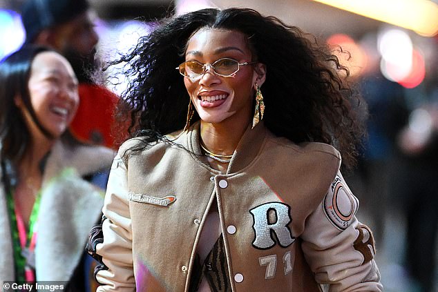 Canadian model Winnie Harlow walks through the paddock before the race on Saturday