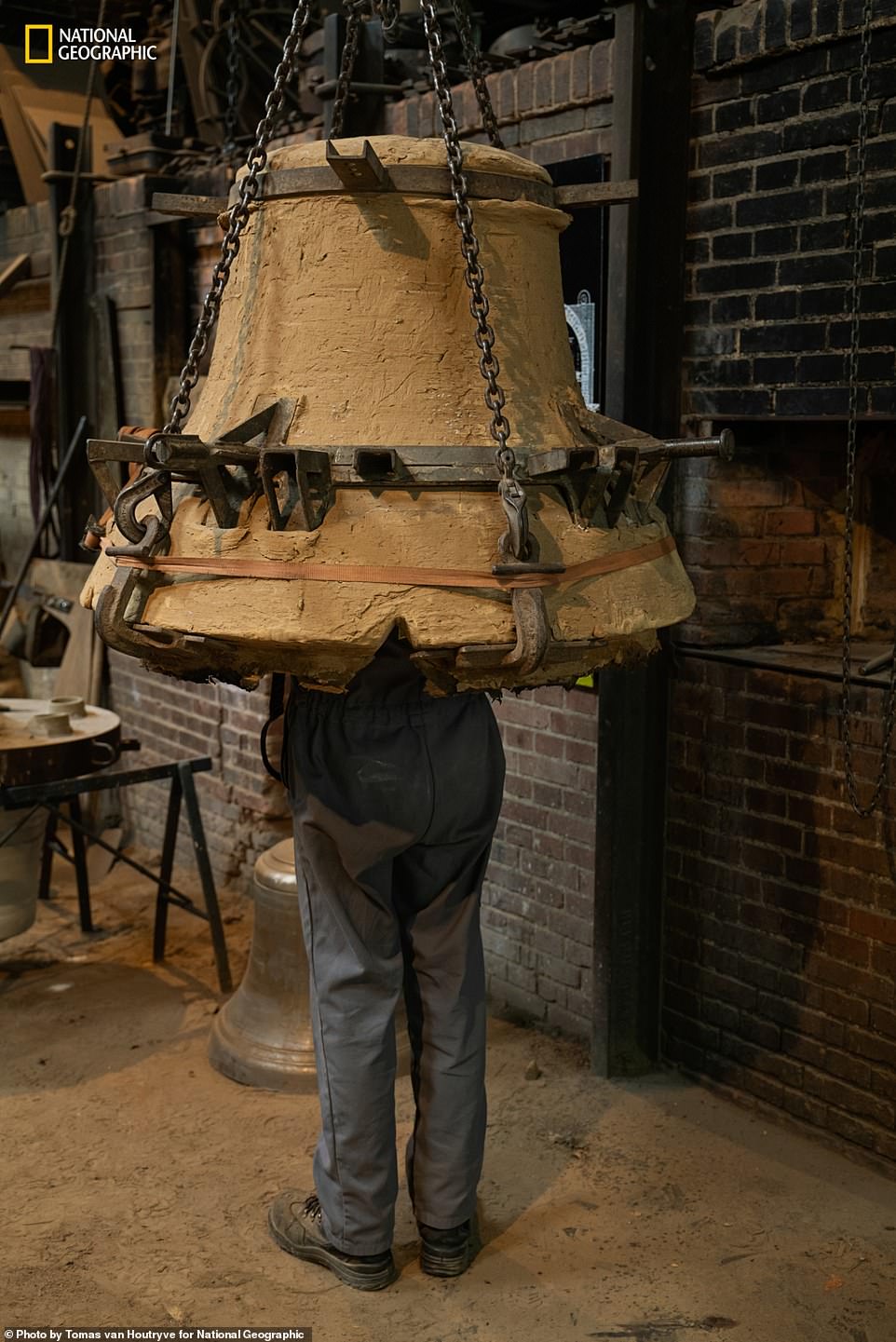 A craftsman inspects a special mold, made at Cloches Cornille Havard, a foundry in Normandy, to repair one of the damaged bells. Nat Geo adds: 'The two bell towers of Notre Dame are home to ten brass bells. The largest is called Emmanuel and hangs in the south tower, where it was undamaged by the fire. The 14-ton copper colossus, cast in 1683 under Louis Eight smaller bells in the north tower had to be removed and cleared of soot; two were damaged and had to be repaired.”