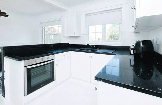 However, the kitchen is the first part of the house where the all-white theme is broken and you notice that the countertop is actually black marble.