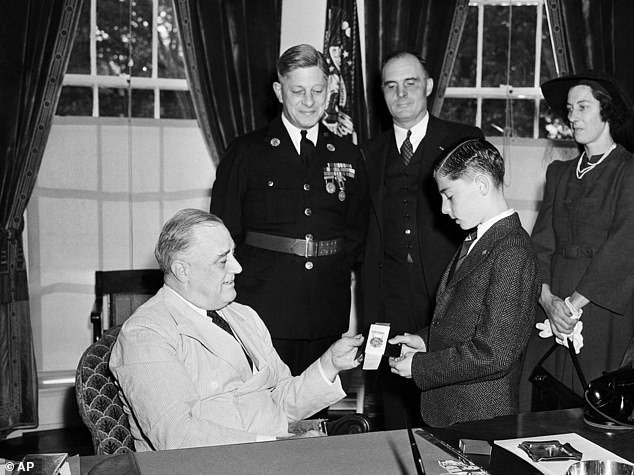 President Franklin Roosevelt presented 14-year-old Donn Fendler of Rye, New York with a gold medal for bravery at the White House in Washington in 1940