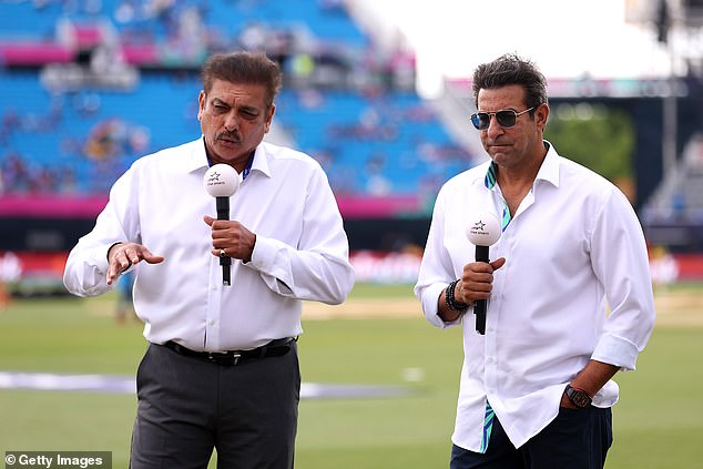 Akram (pictured earlier this year with Ravi Shastri) faced persistent verbal abuse