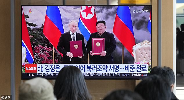 South Koreans look at Kim Jong Un and Vladimir Putin during a recent meeting