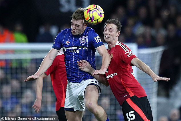 Jonny Evans, who started in the back three, was seen (right) clashing heads with Liam Delap