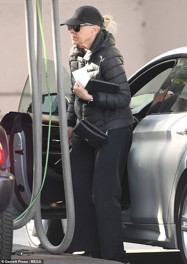 She appears to be embracing her naturally gray hair and kept it low key in a sporty all-black ensemble, wearing a black puffer coat, pants, sneakers and a small crossbody bag.