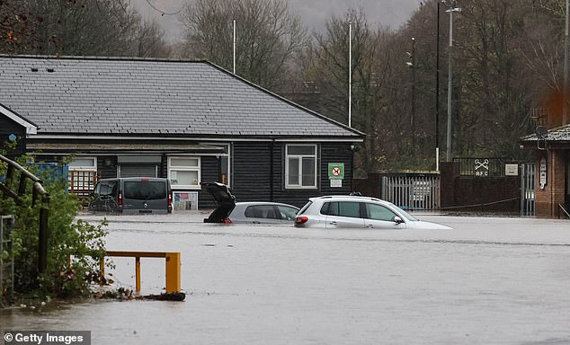 Cars in the Cross Keys Rugby Club car park have been submerged in water as a result of Storm Bert