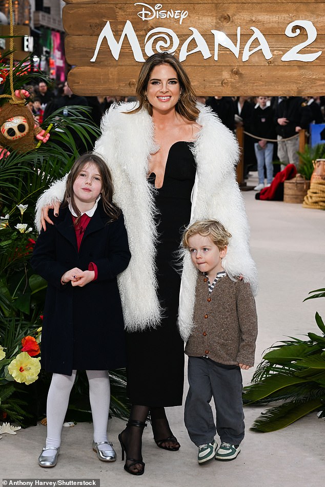 Made in Chelsea's Binky cut a glamorous figure in a busty black Bardot dress as she arrived with her two eldest children, India, seven, and Wolfie, three