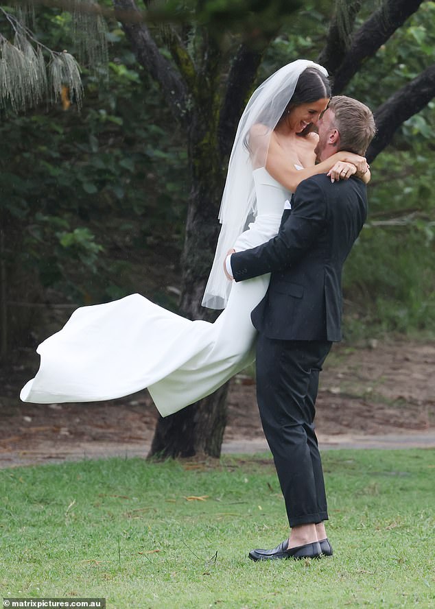 Meanwhile, the happy couple of the hour could barely keep their hands off each other as Luke happily groped his new wife's bum as he lifted her up.