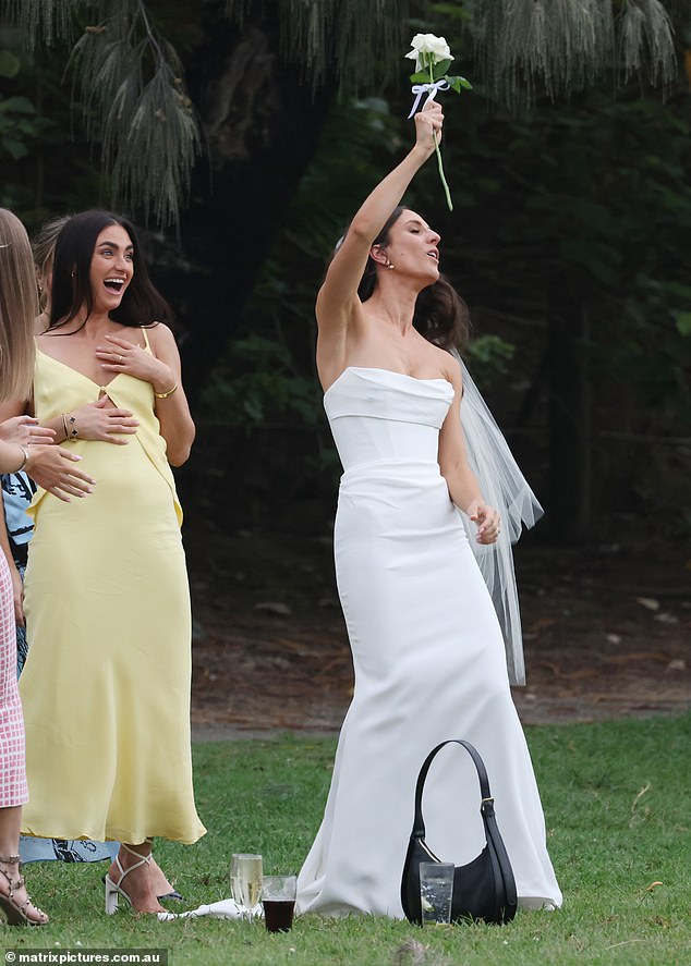 Emily looked stunning as she stole the show in a strapless white dress with a fitted bodice and tight skirt