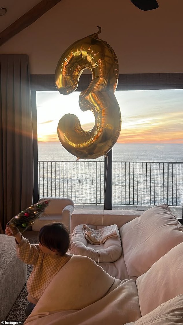 She then shared a photo of Malcolm playing next to their couch, near where the number balloon was tied