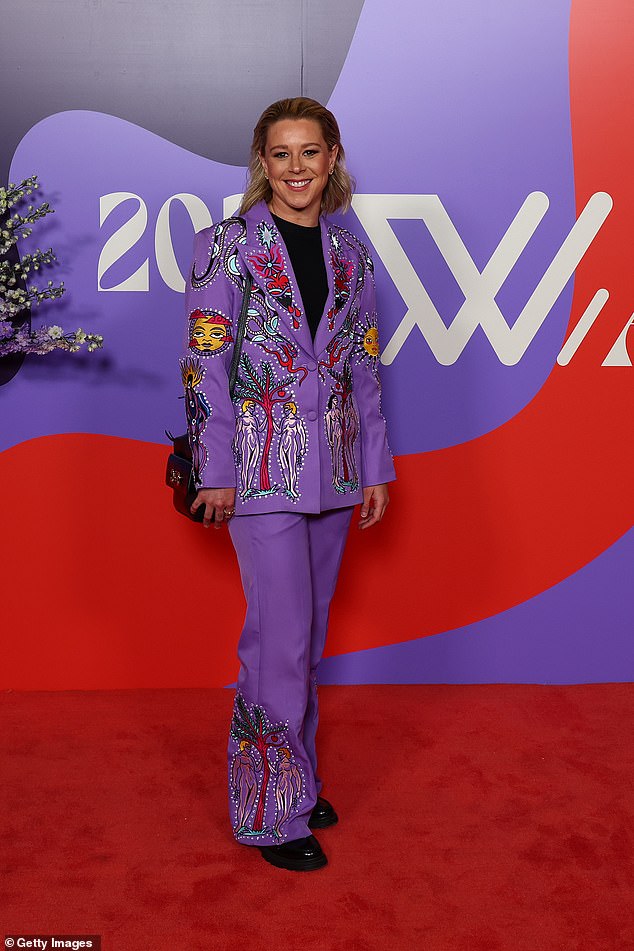 Brisbane Lions star Kate McCarthy stood out in a purple ensemble with a bright cartoony print throughout