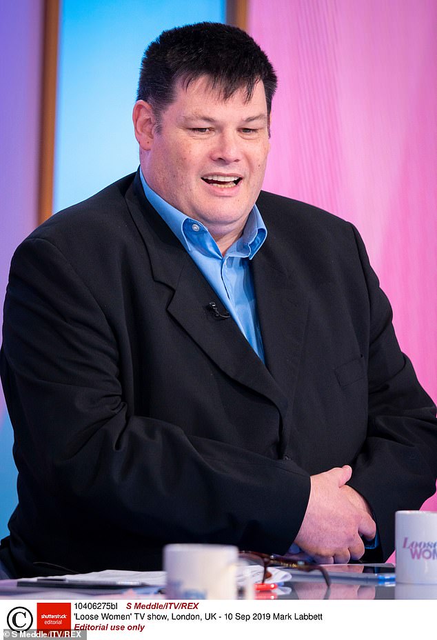 Mark looked noticeably slimmed down in a gray jumper, after The Chase star lost a whopping 10 stone after 'eating less and drinking more' and focusing on his health as he battled diabetes (pictured in 2019)