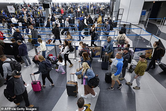 Travelers line up at the security checkpoint at O'Hare International Airport in Chicago, Illinois on November 22, 2024, ahead of the upcoming Thanksgiving holiday