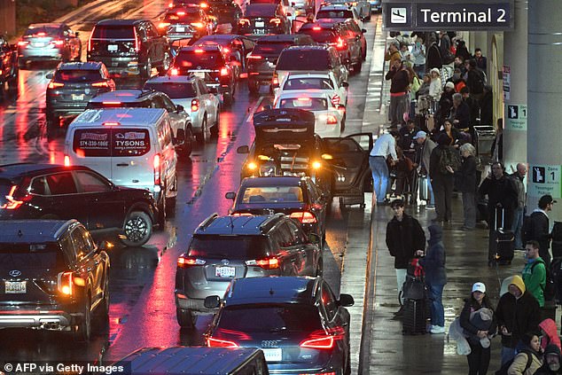 Passengers arrive at Ronald Reagan Washington National Airport in Arlington, Virginia, on November 22, 2024, ahead of the upcoming Thanksgiving holiday