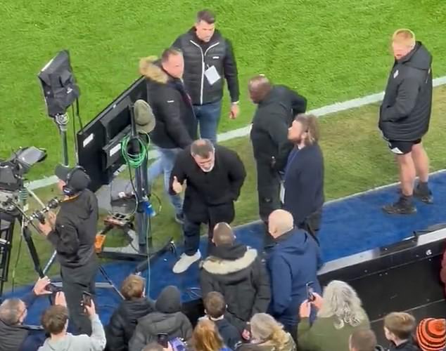 According to a nearby witness (pictured in the blue jacket on the right), the irate fan (pictured in the black jacket with a fur hood) was furious with Keane for previously refusing to give his children an autograph and for being obnoxious.