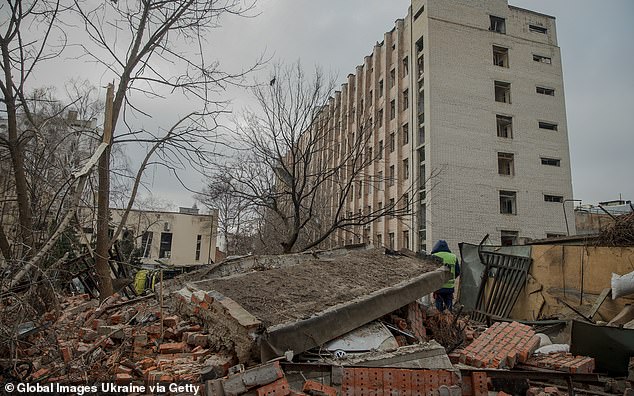 A car lies wrecked under the rubble of a building destroyed by a Russian missile attack on the Kievsky district on November 25, 2024