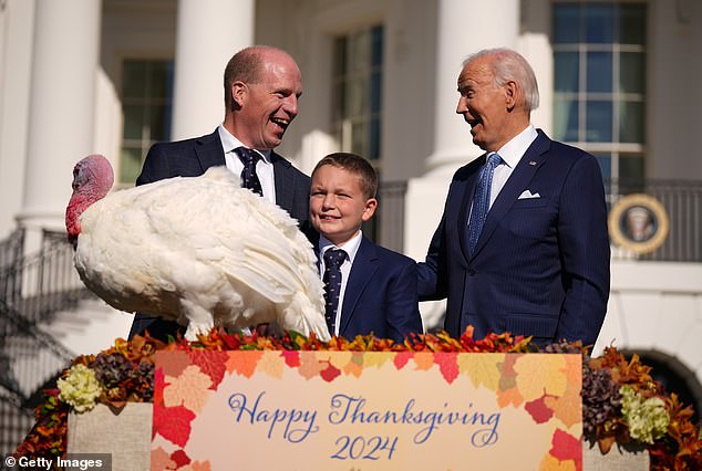 President Joe Biden pardons the National Thanksgiving Turkey Peach, along with National Turkey Federation Chairman John Zimmerman and his son Grant