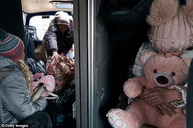 Police evacuate a family from the village of Yelyzavetivka in the Donetsk region of Ukraine, towards Kurakhove, on November 14