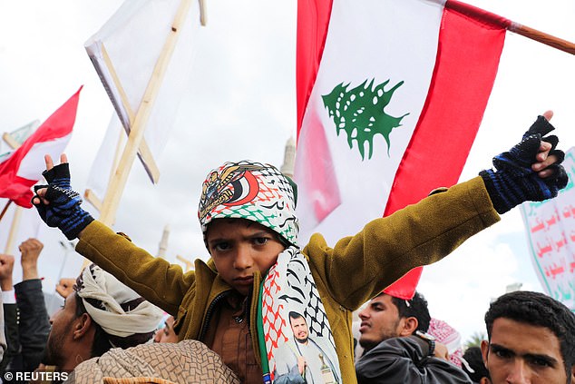 A child gestures as protesters, mostly Houthi supporters, gather to show support for Lebanese Hezbollah and Palestinians in the Gaza Strip, in Sanaa, Yemen, November 22, 2024