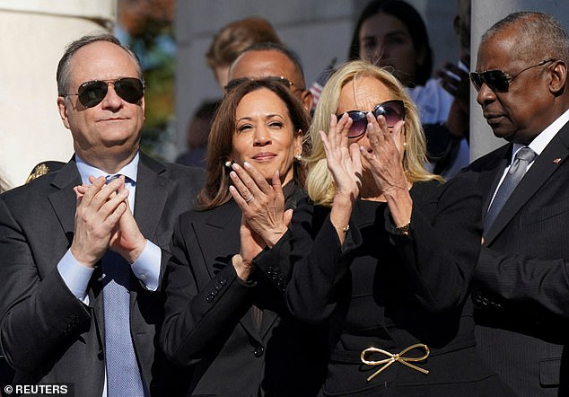 U.S. Vice President Kamala Harris, U.S. First Lady Jill Biden, Second Gentleman Doug Emhoff and Defense Secretary Lloyd Austin listen to U.S. President Joe Biden's remarks during a wreath-laying ceremony on Veterans Day.