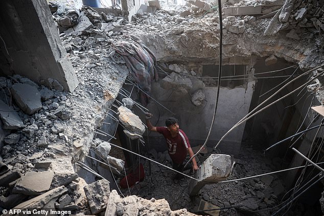 A Palestinian inspects the rubble of a house destroyed during an Israeli attack on the Bureij refugee camp in the central Gaza Strip on November 24, 2024