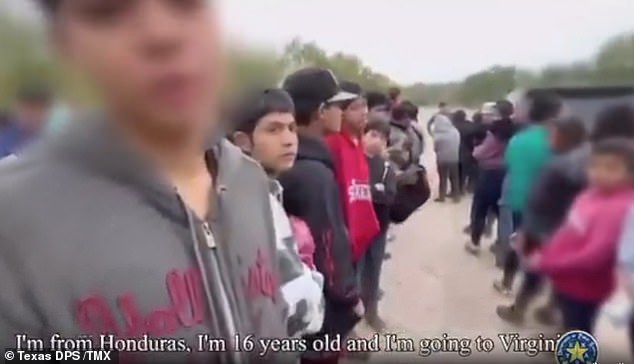 The toddler, dressed in a bright pink jacket, was part of a staggering group of more than 200 illegal migrants – including 60 unaccompanied minors – detained on Sunday