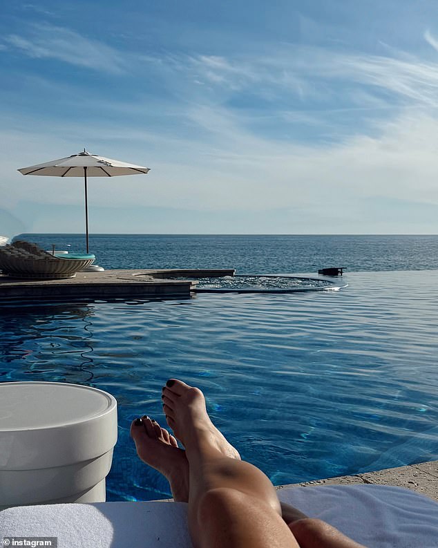 Another photo captured her tanned legs as she lounged by her pool, overlooking the ocean