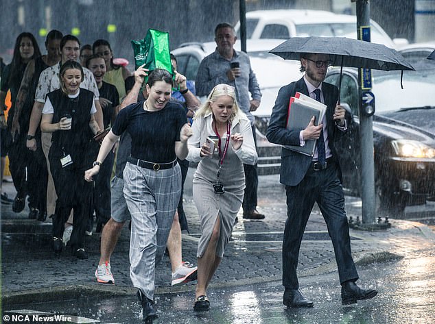 Mr How large parts of the country could reach and even exceed average monthly rainfall for November on Friday evening (photo, CBD workers in Brisbane dodge the rain)