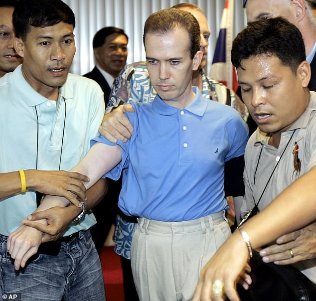 Officials announced in 2006 that the suspect, John Mark Karr (pictured center), had been arrested in Bangkok, Thailand, but DNA testing failed to link him to the crime scene.