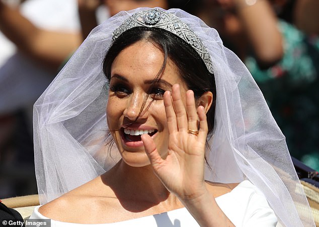 Meghan waves the tiara on her head during her wedding at St George's Chapel at Windsor Castle on May 19, 2018